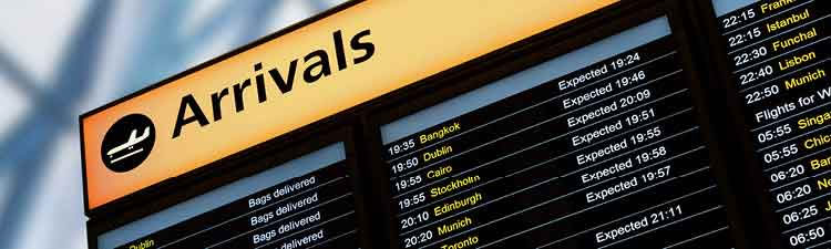 Airport arrivals sign listing arriving flights