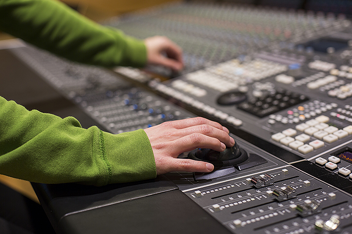Student using SSL Duality SE Console in mixing suite with Avid Pro Tools HDX system