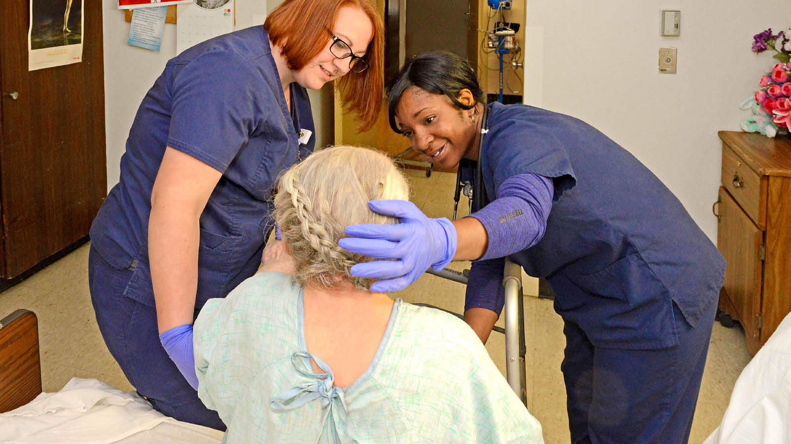 Healthcare professional students working with a patient