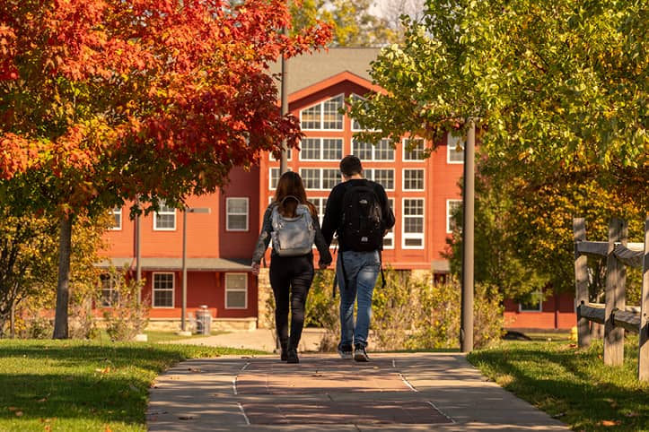 Students walking the path to the Suites at Laker Landing adjacent to the main campus at FLCC